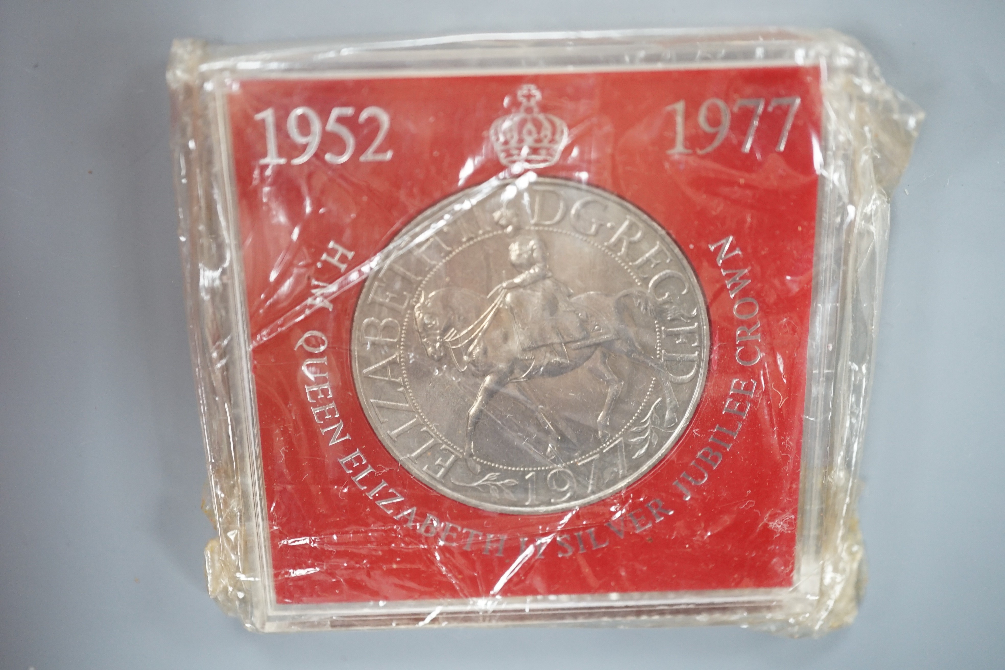 A collection of coins including a Victoria crown and two florins